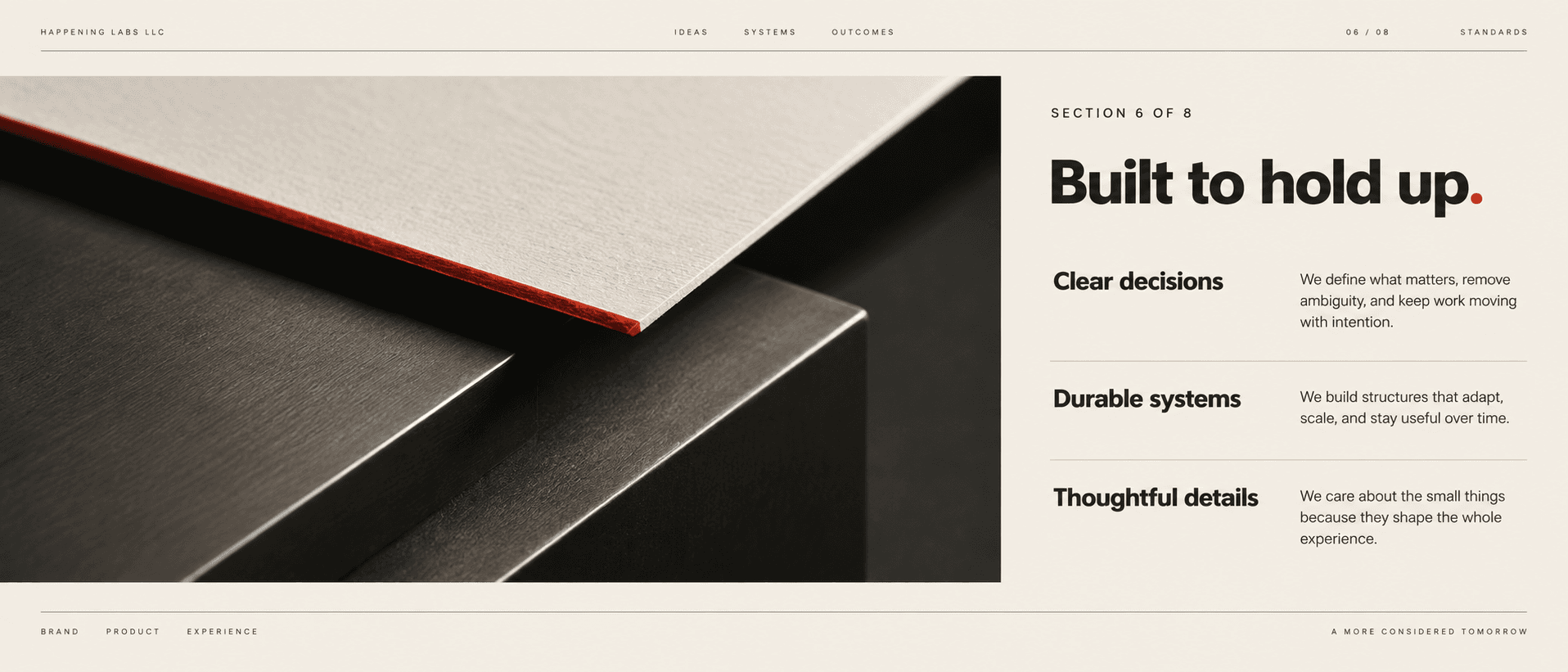 Close view of ivory paper with a vermilion edge above dark metal